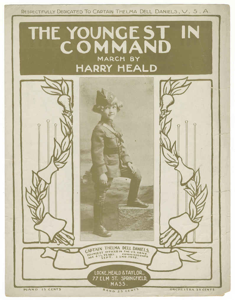 Cover of a sheet music book. Text: 'The Youngest in Command / March By / Harry Heald' Image: a black and white photograph of a young girl wearing a military uniform.