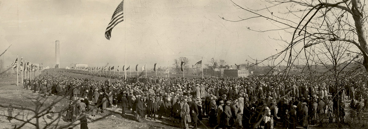 Sepia panorama of a large crowd filling the mall in front of the Liberty Memorial.