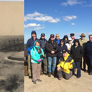 Modern photograph of a group of tourists posing in front of a round metal structure in a field. Overlaid over the top of the left side of the photo is an old black and white photograph of the same structure.