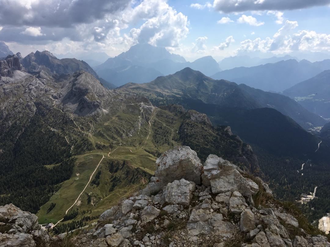 Looking down at a mountain ridge with a long winding trail across the top.