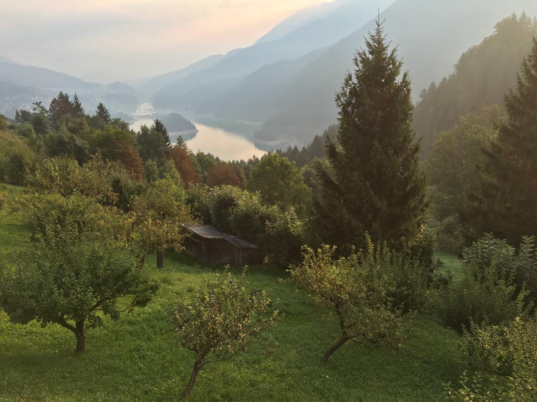 The Asiago Plain - a green valley with a shining river flowing away in the distance