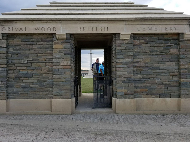 Photograph of an imposing gate built of slate-grey bricks.