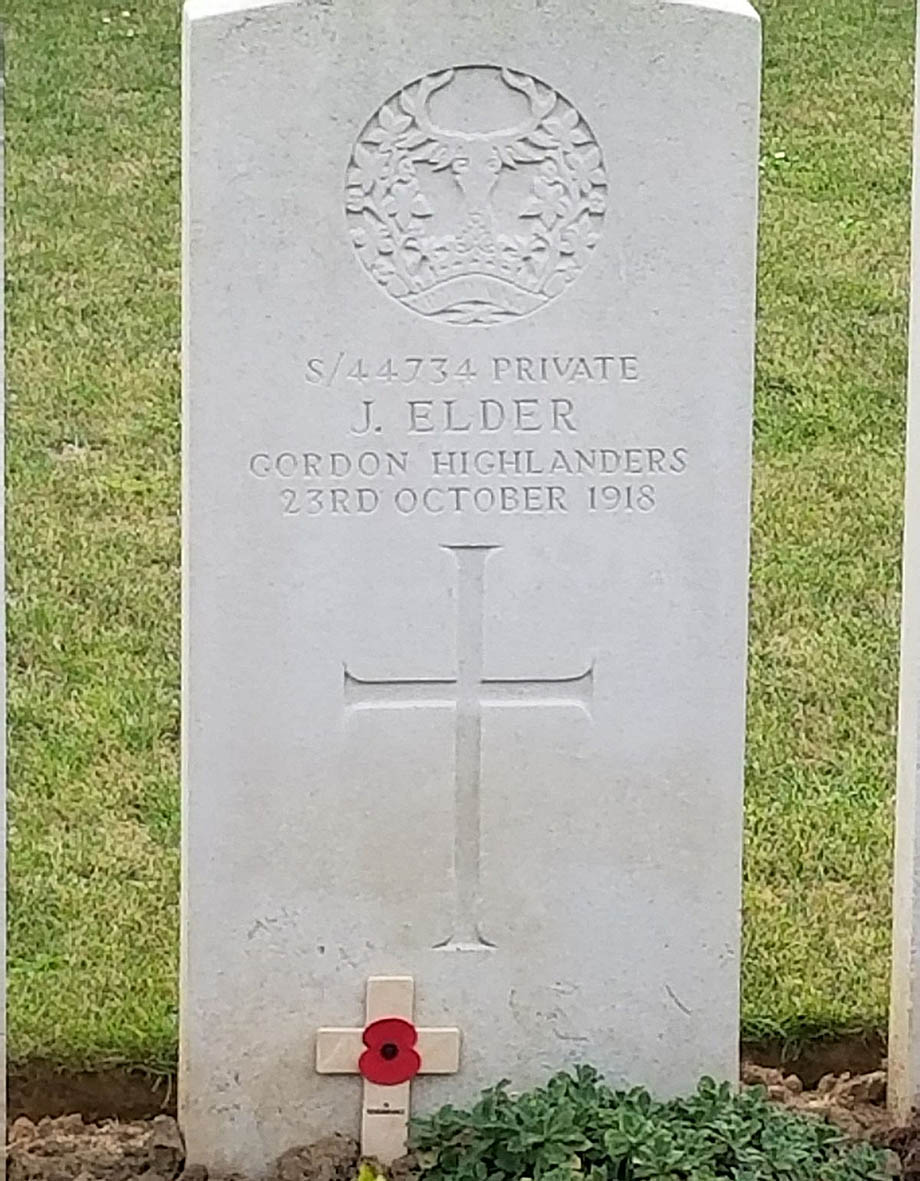 Rectangular white stone grave marker.