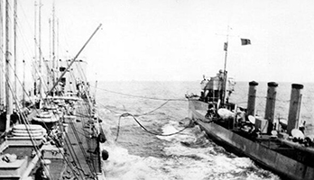 Black and white photograph of two battleships at sea