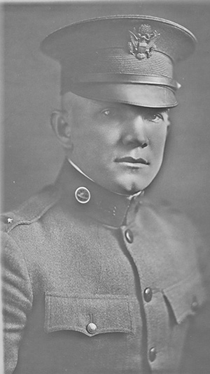 Black and white portrait photograph of a white man in uniform.