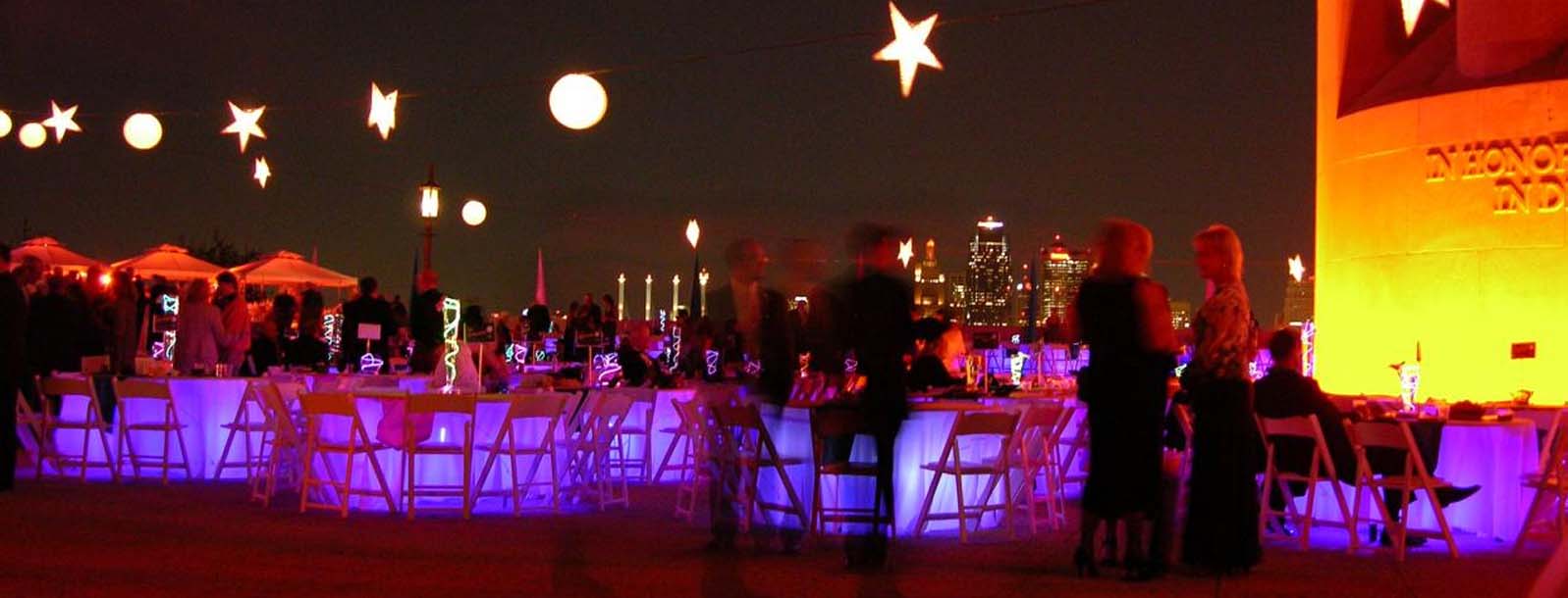 Nighttime dinner and party on the memorial courtyard at the base of the tower