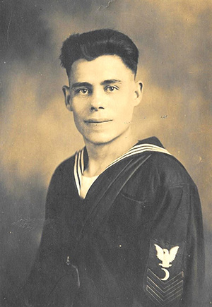Black and white portrait photograph of a young man dressed in a naval uniform.