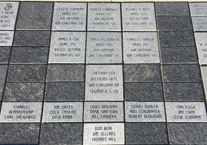 Picture of slate-grey bricks etched with various dedications.
