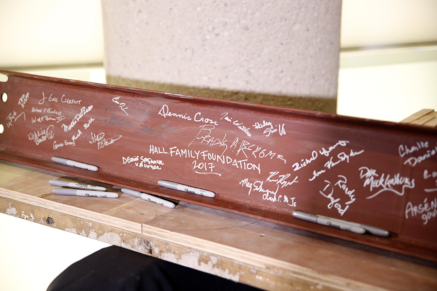 Modern photo of a steel I-beam covered in signatures in silver sharpie