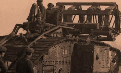 Men riding atop a tank