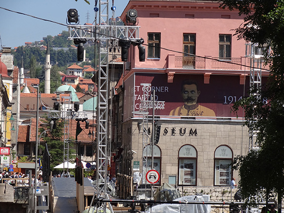 Photo of a banner depicting a mustached man hanging on a building