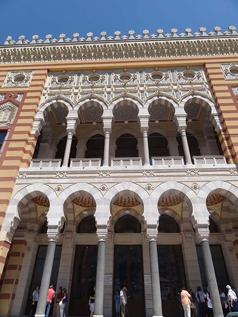 Front facade of a building with delicate archways and carvings