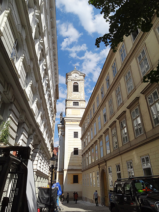 View down a city street toward a white church tower