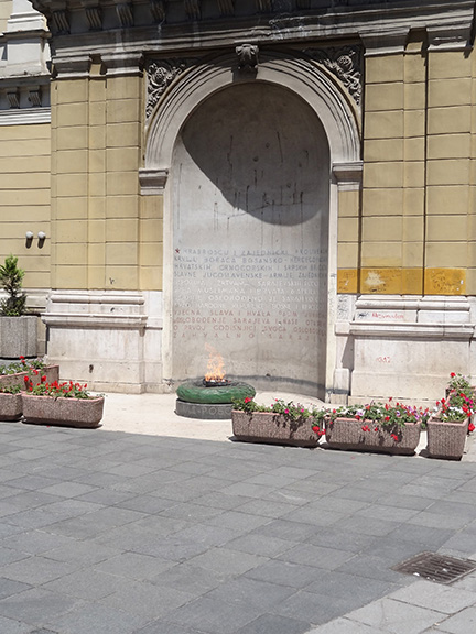 An eternal flame set in an alcove outdoors