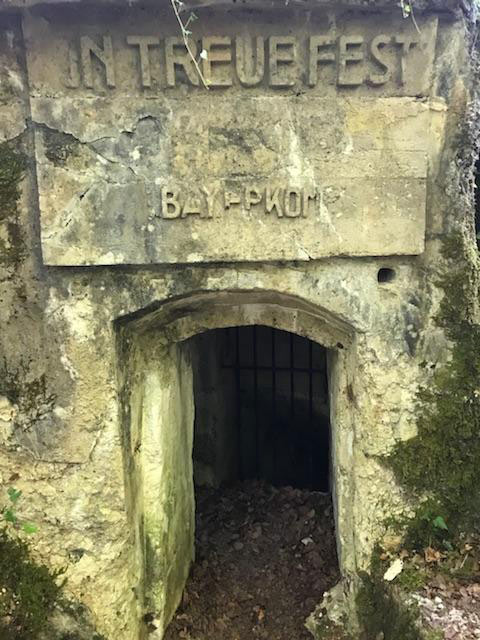 Entrance to an underground bunker. Carved over the arch: 'In Treue Fest'
