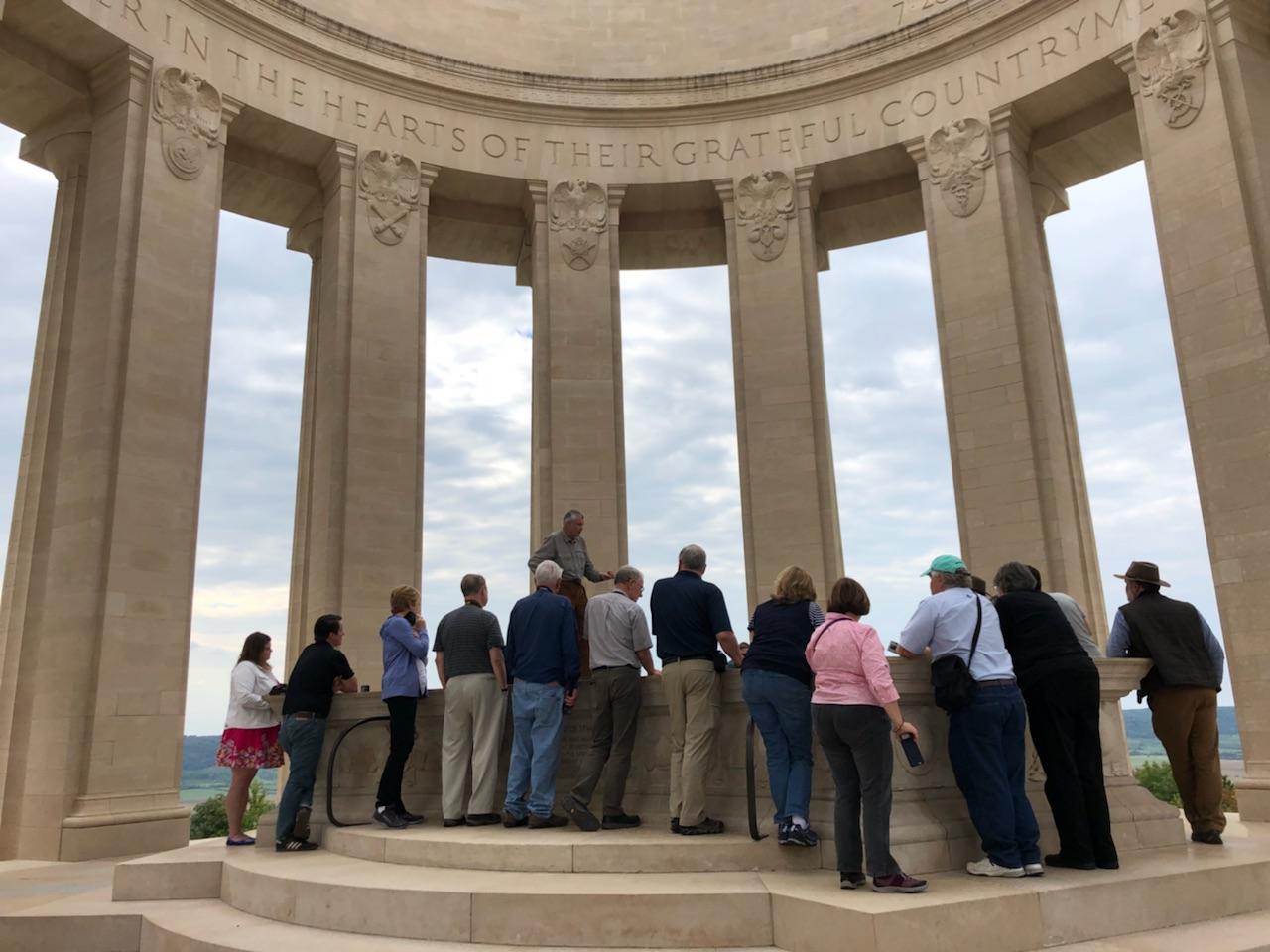 Tour group standing inside the circular pillar monument