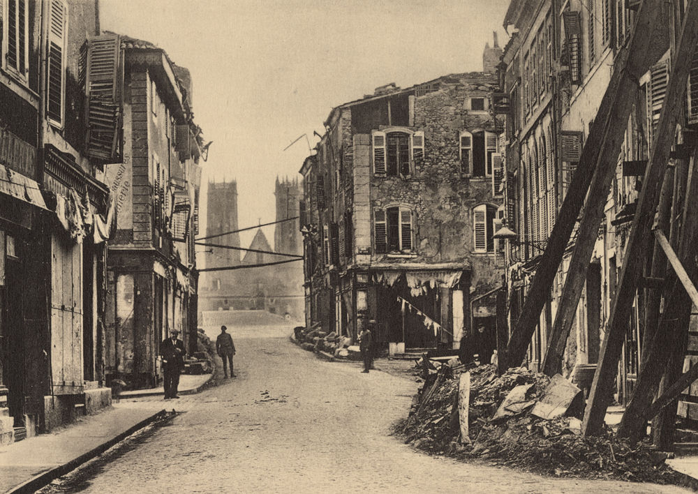 Sepia photograph of war-torn village buildings