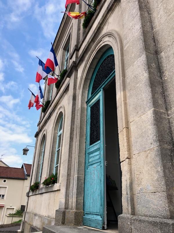 A bright blue door in a gray stone facade.