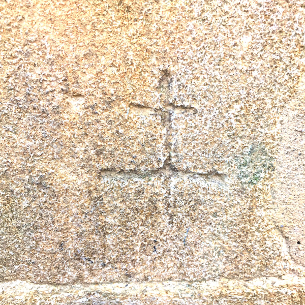 Small etched marking in stone