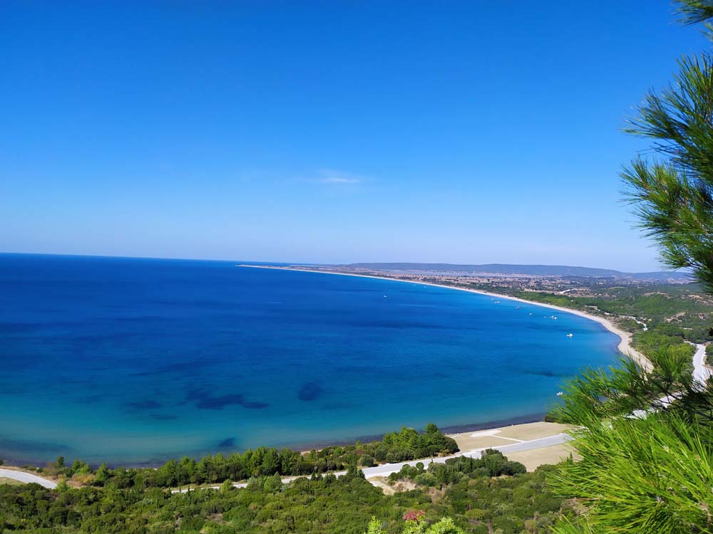 View overlooking a large blue-green ocean bay on a sunny day