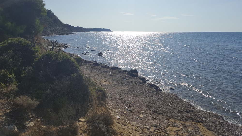 View of a small rocky beach on a sunny day.