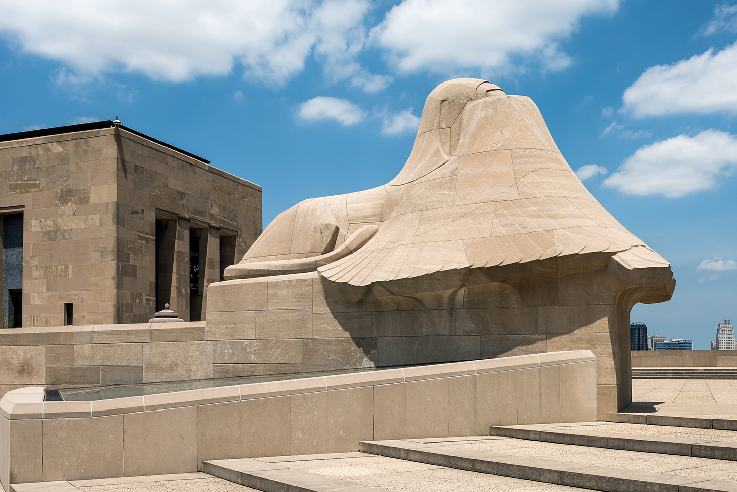 One of the winged Assyrian sphinxes. Most of the sphinx is covered by its wings.