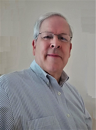 Selfie of an older white man with grey hair and wire glasses