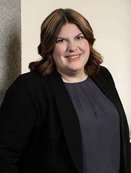 Modern photograph of a white woman with shoulder-length light brown hair.