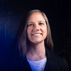 Headshot of a white woman with shoulder-length light brown hair.