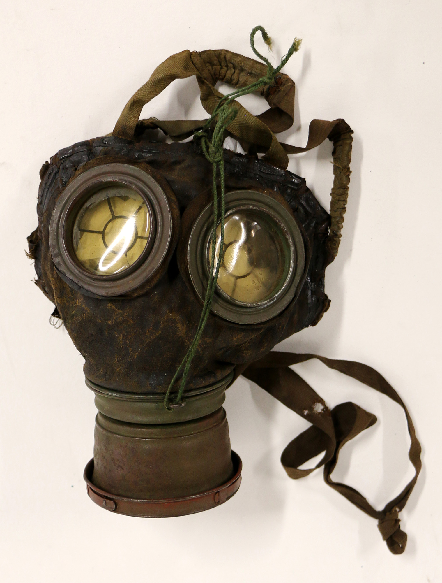 Modern photograph of a WWI-era gas mask against a white background