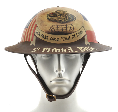 Photograph of a mannequin head wearing a steel doughboy helmet painted with flags and tanks