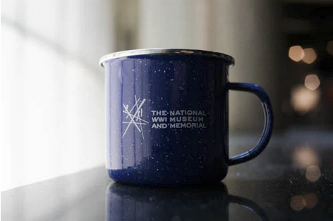 Photograph of a blue tin mug printed with the Museum logo