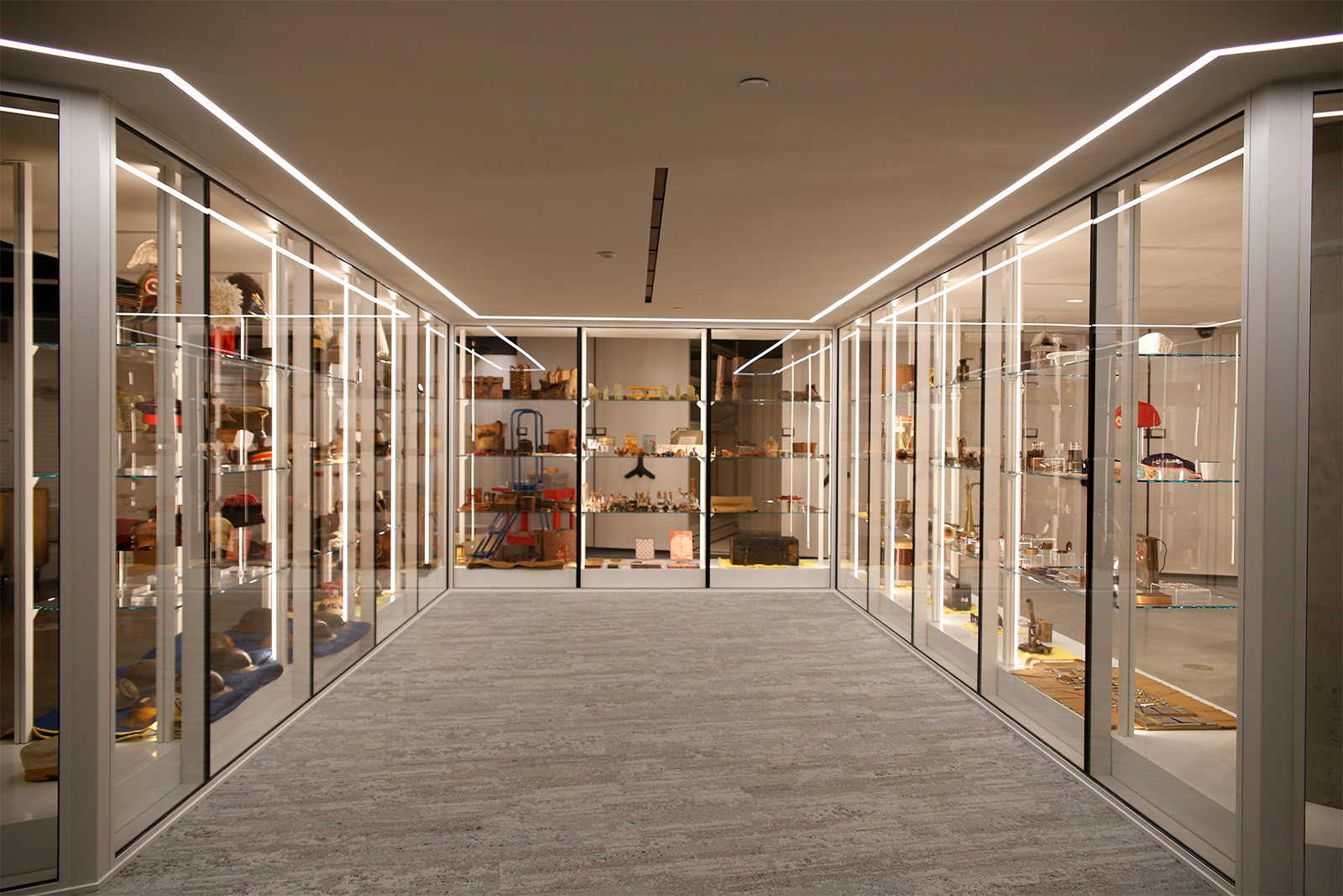 Modern photograph of an alcove bounded on three sides by glass display cases, filled with WWI artifacts