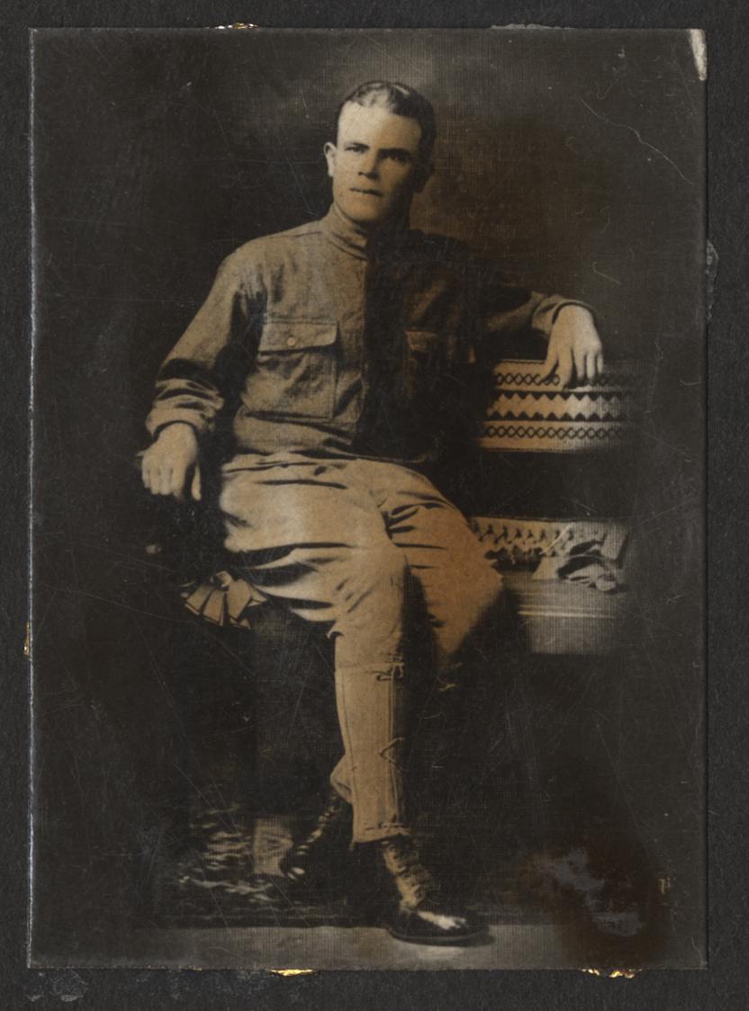 Black and white portrait photograph of an American soldier seated, wearing military uniform. 