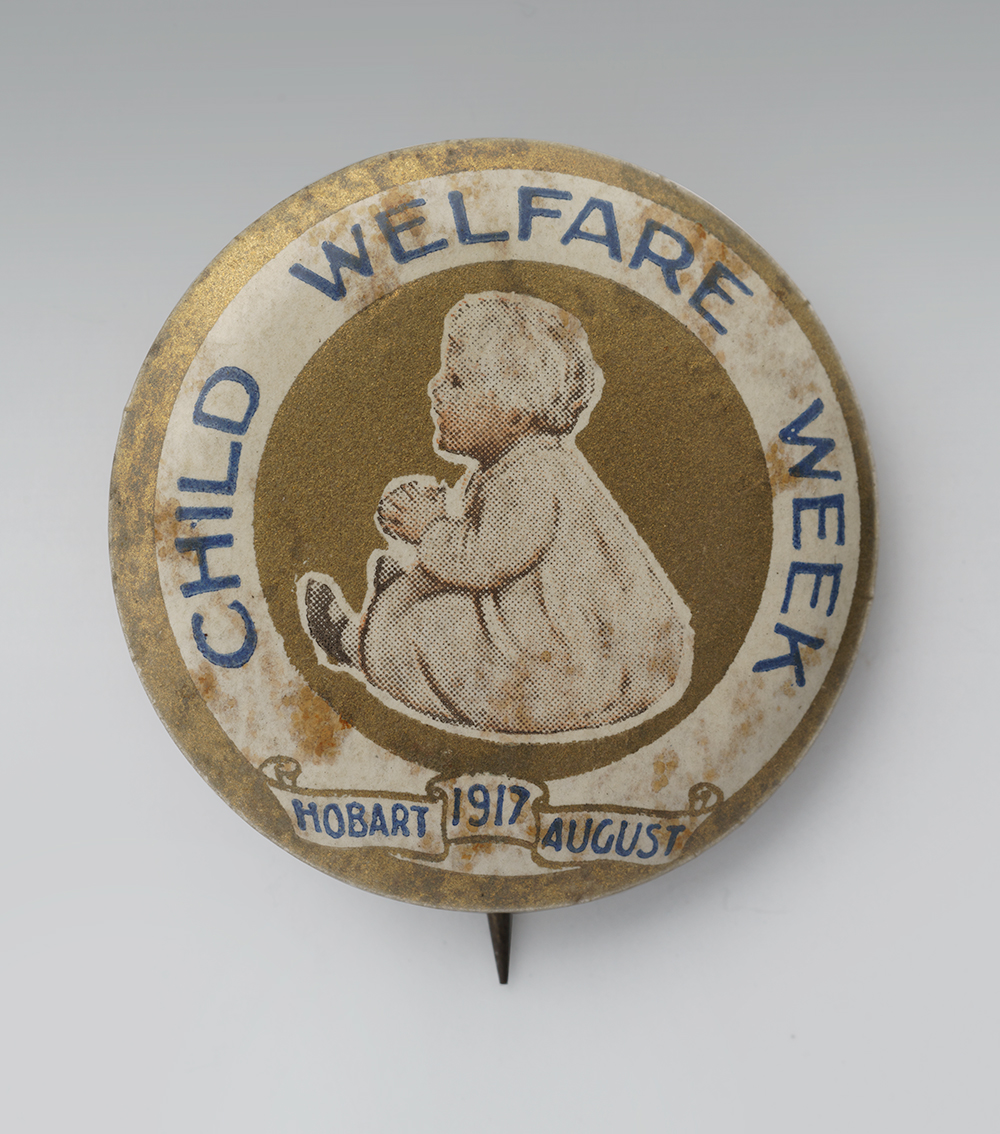 Circular pin with an illustration of a small white child sitting in the middle. Text running along the edge: 'Child Welfare Week'