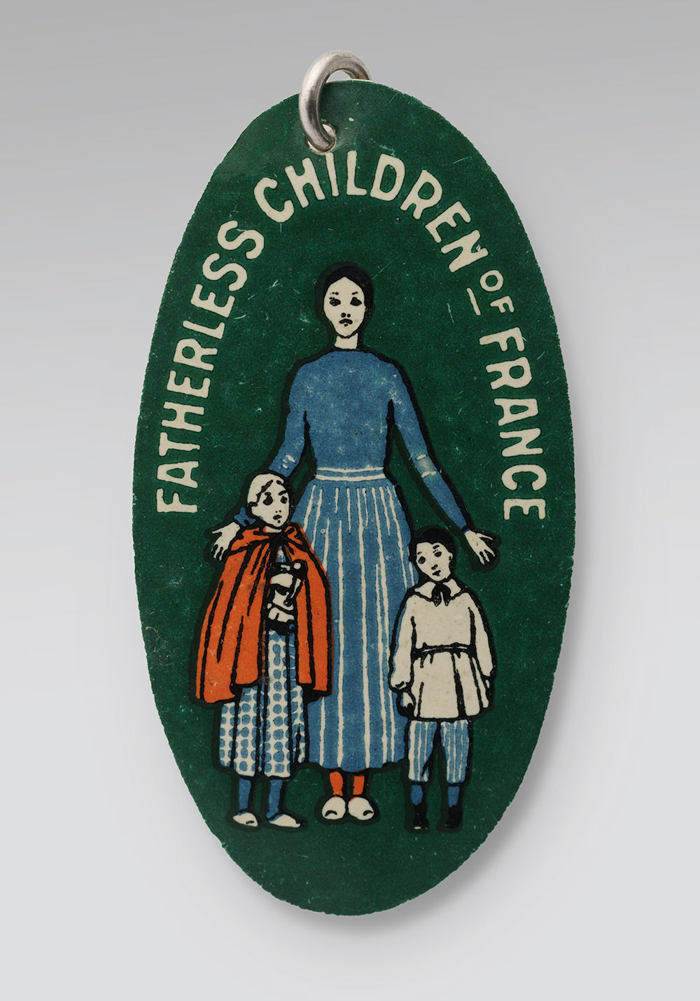 Oval pin with a green background. Illustrated with drawings of a woman and two children. Text along the top edge: 'Fatherless Children of France'