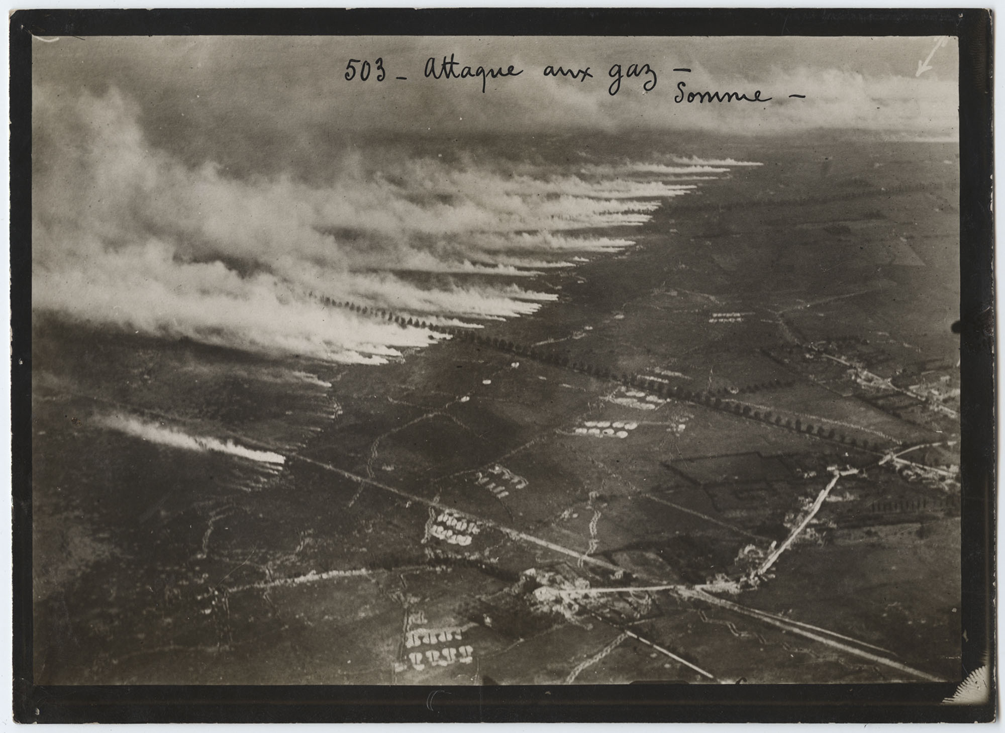 Black and white aerial photograph of fields covered in gas and smoke