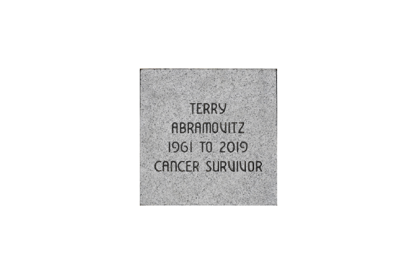Square grey granite brick inscribed 'TERRY / ABRAMOVITZ / 1961 TO 2019 / CANCER SURVIVOR'