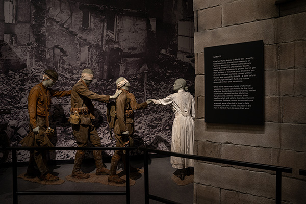A nurse mannequin leads a line of three soldier mannequins blinded by mustard gas towards the field hospital exhibit
