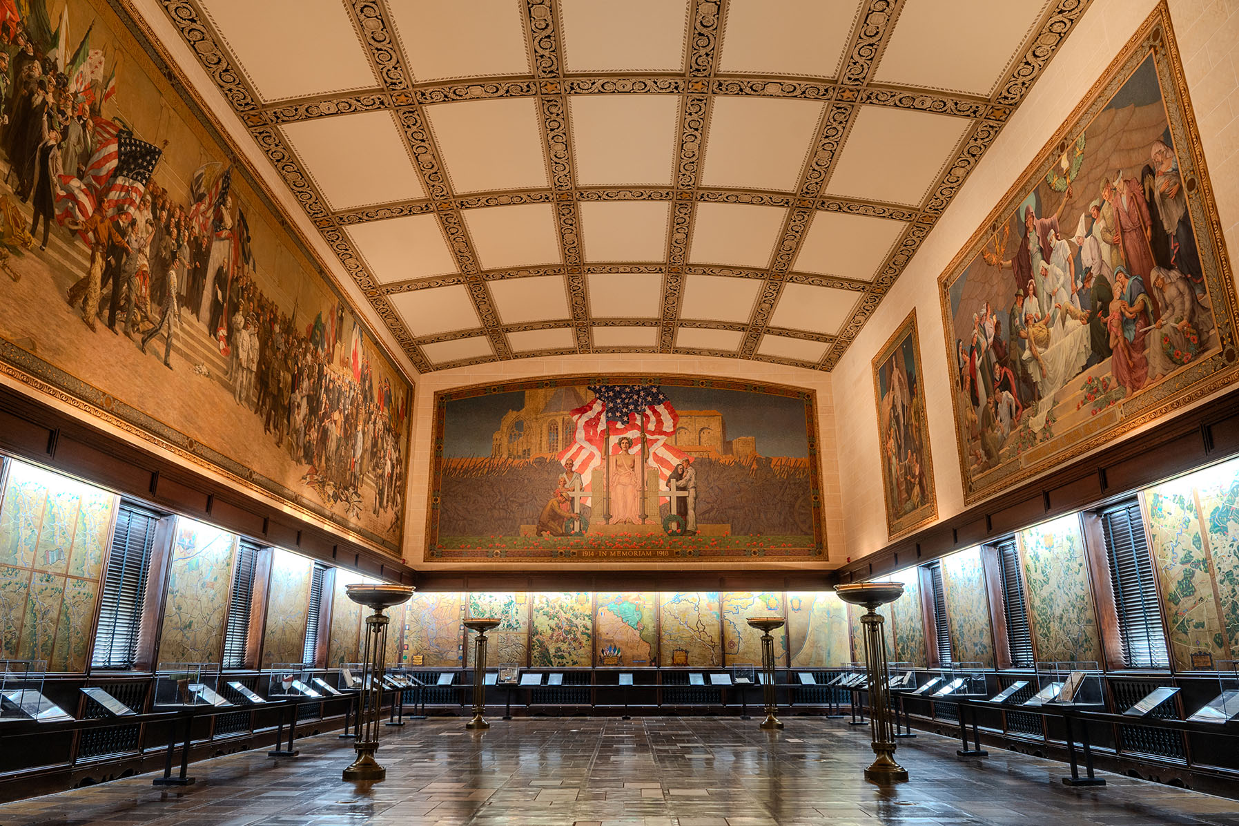 Exhibition hall space lined with large paintings