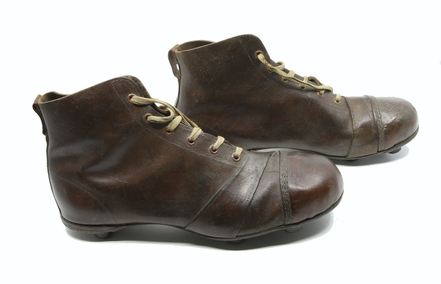 Pair of leather boot-shaped footwear with thick cleats on the sole.