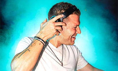 A smiling white man wearing professional headphones