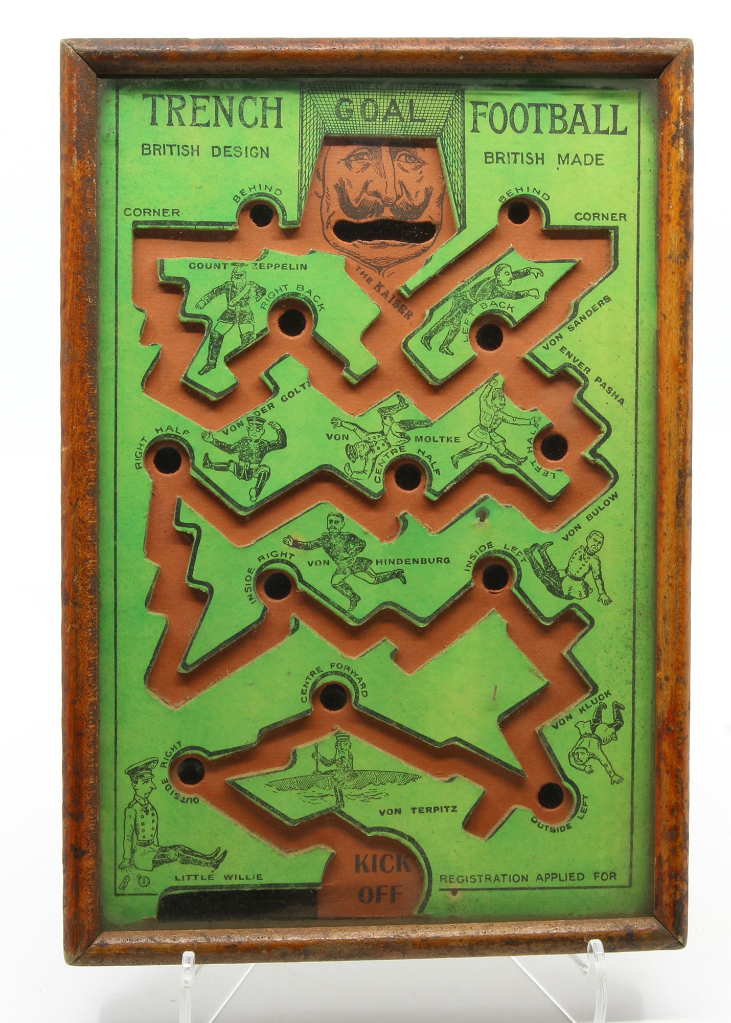 Photo of a board game depicting a crooked "trench" that a ball bearing rolls along attempting to avoid holes cut into the trench along the way.
