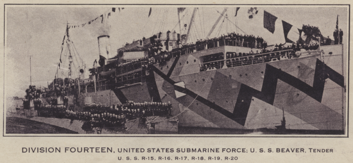 Black and white photo of a large military ship with zig-zag camouflage. Soldiers sit and stand all around the ship's deck, posing for the photo. The caption below states "DIVISION FOURTEEN, UNITED STATES SUBMARINE FOURCE: U.S.S. BEAVER, TENDER | U.S.S. R-15, R-16, R-17, R-18, R-19, R-20