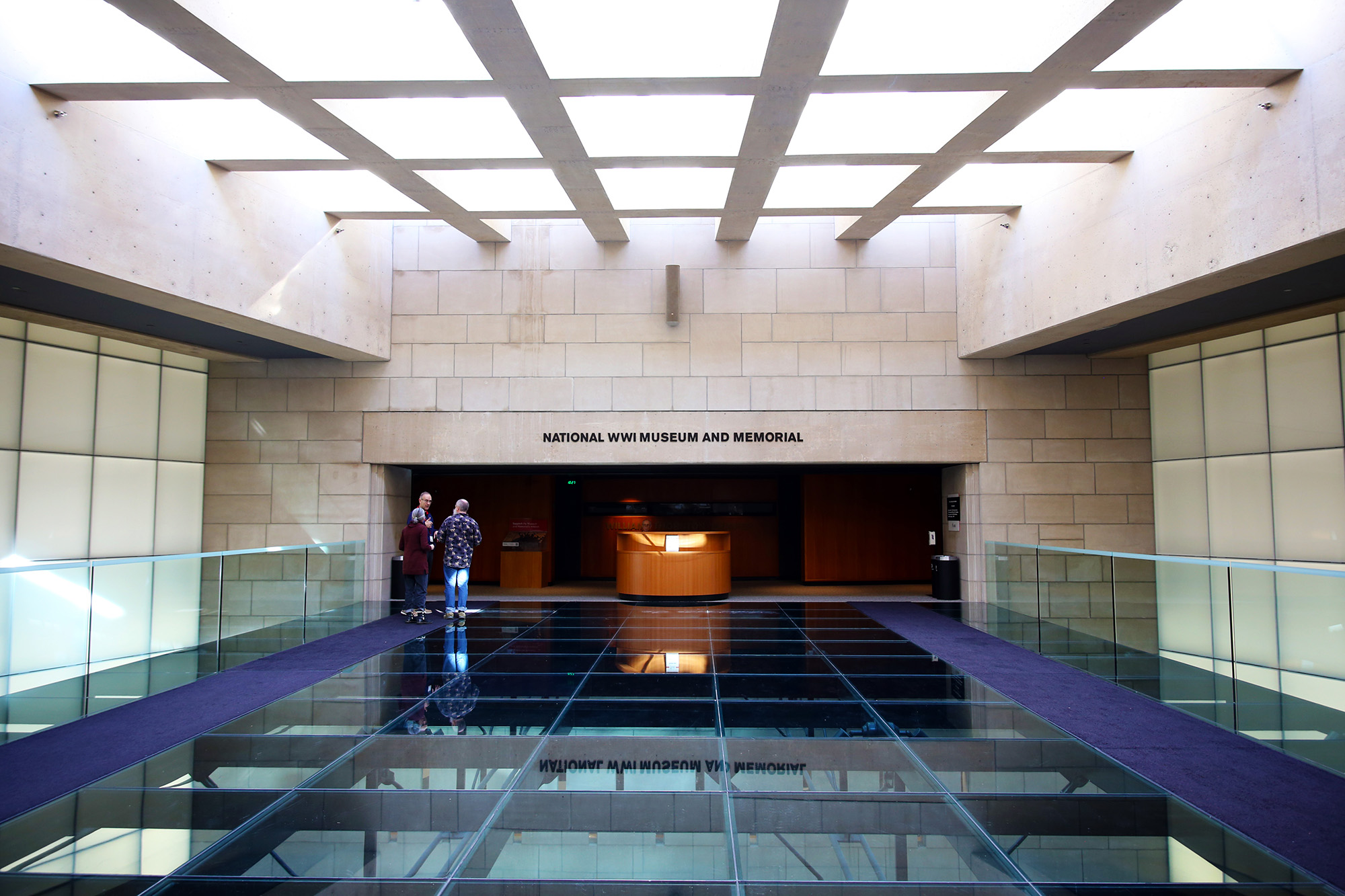 Glass bridge leading towards a museum gallery entrance