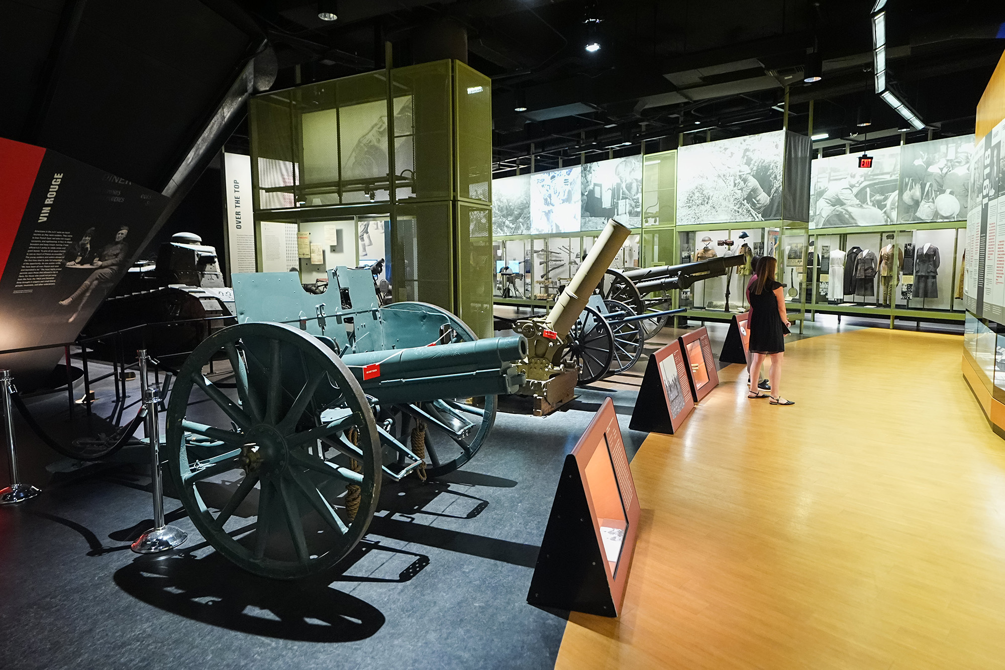Modern photo of an expansive museum gallery filled with WWI artillery and glass cases of artifacts
