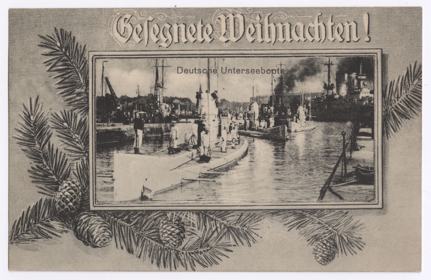 Black and white photograph of several German submarines and a battleship behind them. There are sailors standing on the submarines and they are driving near land. There is a border around the image with drawn branches of a pine tree and with pinecones. Text across the top,over the photograph reads in German, "Deutsche Unterseeboote".