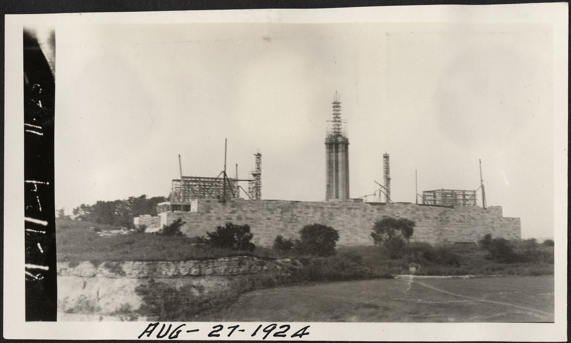 Black and white photo of Liberty Memorial Tower under construction surrounded by scaffolding