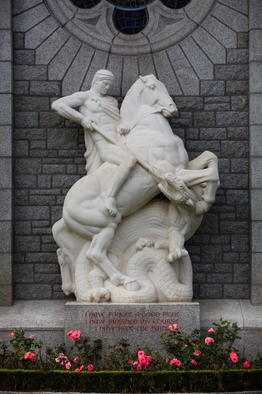Color photograph of a statue of a horse with a person riding it.