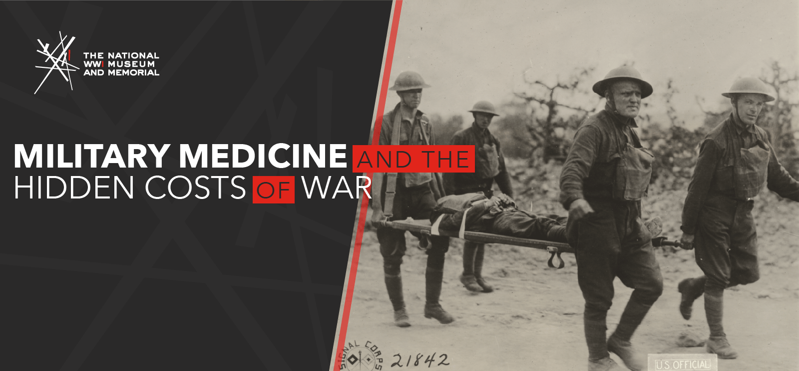 Black and white photo of four WWI soldiers carrying a fifth soldier on a stretcher